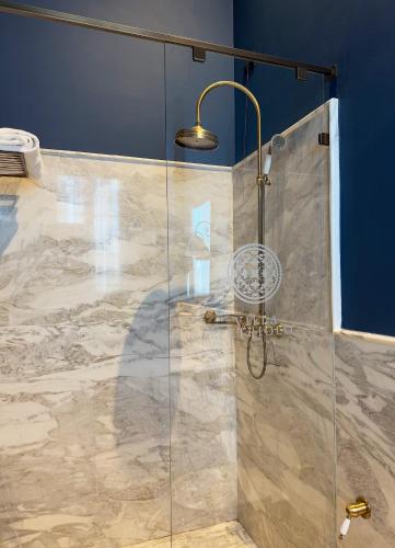 a shower with a glass door in a bathroom at Villa Petriolo - Small Luxury Hotels of the World in Cerreto Guidi
