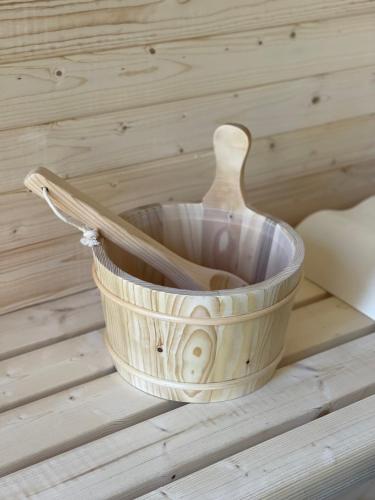 a basket with a wooden spoon in it on a table at Le Sabot in Nassogne