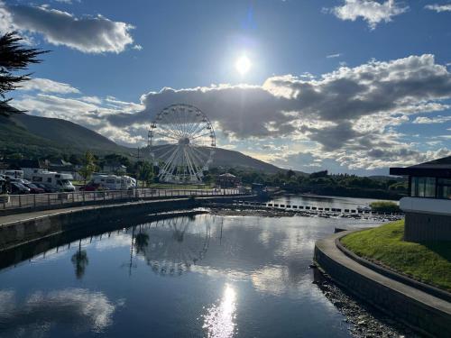 a ferris wheel and a river with a ferris wheel at Betty's Cottage in Newcastle