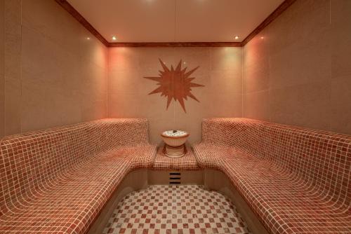 a jacuzzi tub in a bathroom with a spider on the wall at Hotel Regina in Obergurgl