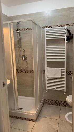 a bathroom with a shower and a sink and a toilet at Il Giardino della Torre in Torre Maggiore