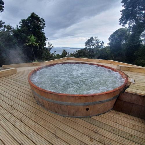 a hot tub sitting on a wooden deck at Hotel Nubes de Quinchao in Quinchao