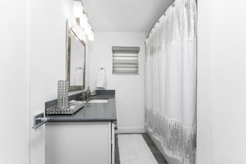 a bathroom with a sink and a shower curtain at Villa Tranquility-Waterfront-Punta Gorda, FL in Punta Gorda