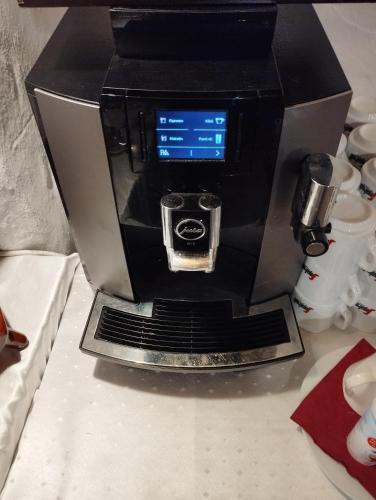 a coffee machine sitting on top of a counter at Régi Posta Hotel és Étterem in Debrecen