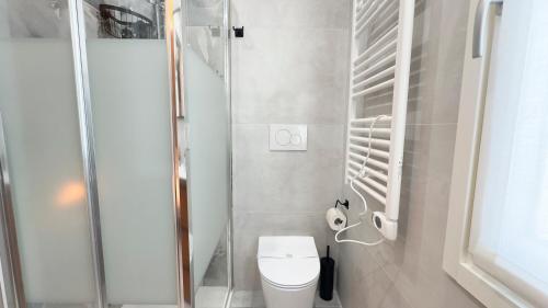 a small bathroom with a toilet and a shower at Do Campanili by Ca-Sa Check in Chioggia