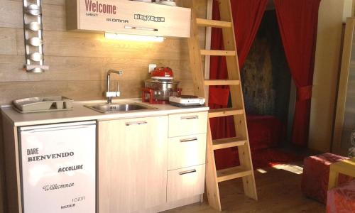 a small kitchen with a sink and a ladder at MODERN Studio & Loft in Pálioura