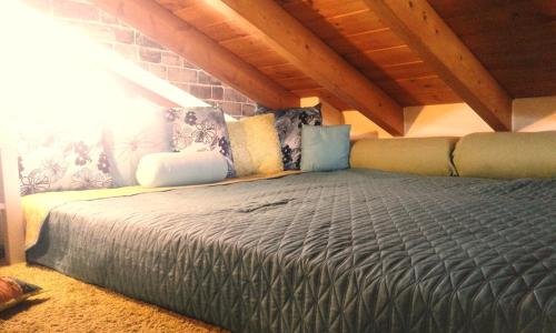 a large bed in a room with a attic at MODERN Studio & Loft in Pálioura