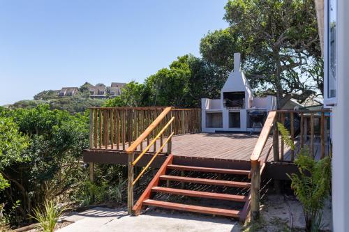 a deck with a stove on the side of a house at A Stone's Throw from the Ocean in Seafield