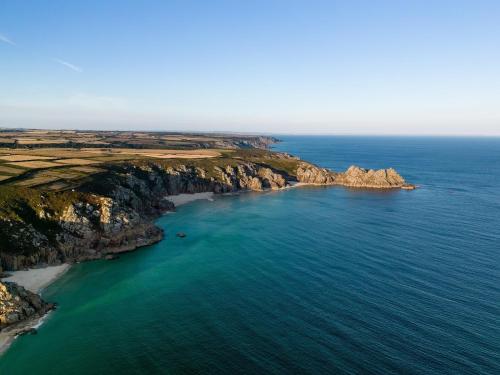an aerial view of the ocean and a rocky coast at 5 min walk to beach with parking and private sauna in Falmouth