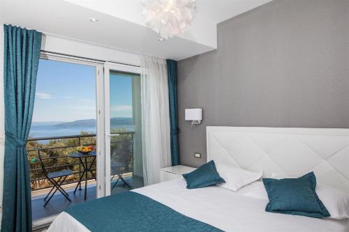 a bedroom with a bed and a large window at Villa Red with pool and sea view in Makarska