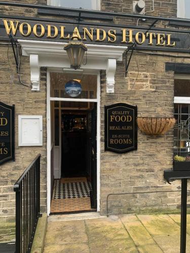 a woodlands hotel sign on the front of a building at The Woodland's Hotel in Bradford