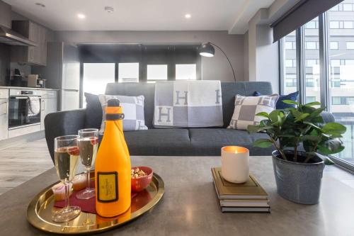 a bottle of champagne on a tray on a table in a living room at BRAND NEW Luxury Home by City SuperHost in Liverpool