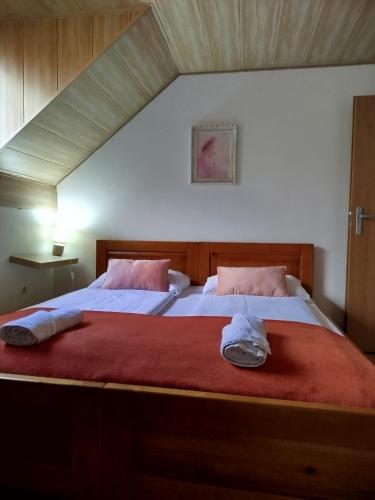 a bedroom with a large bed with a red blanket at Guest House Kovalik in Suchá Hora