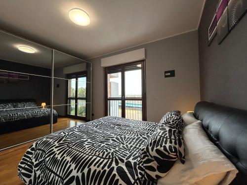 a bedroom with a zebra print bed and a mirror at Casa Vacanze Asia Da Vinci's House in Fiumicino