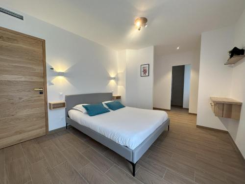 a bedroom with a bed with blue pillows on it at Villa Dyane in Salavas