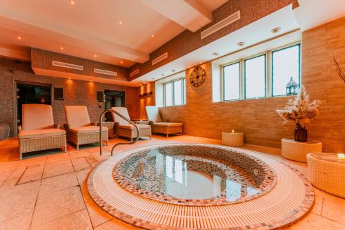 a large room with a large pool in the middle of it at Ellenborough Park in Cheltenham