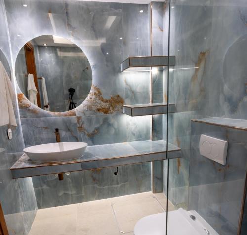 a bathroom with a sink and a mirror at Zoli house in Pefkochori