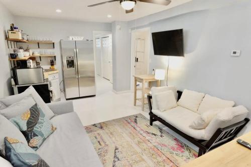 a living room with a couch and a tv at 16th St Heights Family Haven in Washington, D.C.