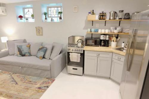 a living room with a couch and a kitchen at 16th St Heights Family Haven in Washington, D.C.