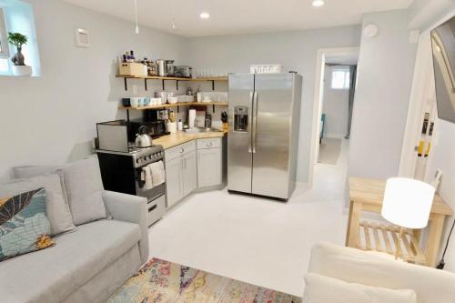 a living room with a stainless steel refrigerator at 16th St Heights Family Haven in Washington, D.C.