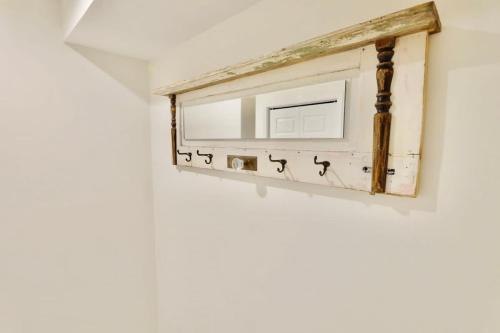 a mirror hanging on a wall with birds on it at 16th St Heights Family Haven in Washington, D.C.