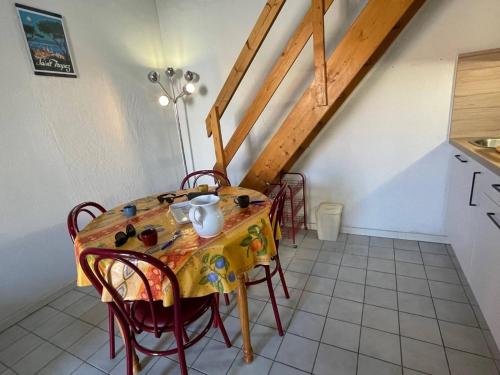 une cuisine avec une table et des chaises dans une pièce dans l'établissement Maison 2 pièces avec mezzanine - Argelès-sur-Mer AR150-013, à Argelès-sur-Mer
