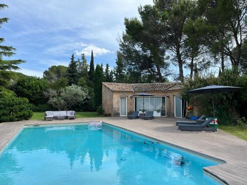 une piscine devant une maison dans l'établissement Le p’tit bonheur-Piscine chauffée-clim-Park, à Carpentras