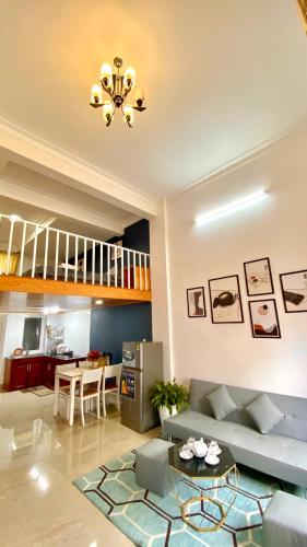 a living room with a couch and a table at Lê Mùi Hotel - Apartment in Da Thien