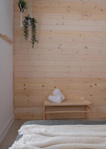 a room with a wooden wall with a bench at Armoni Ski & Spa in Cantley