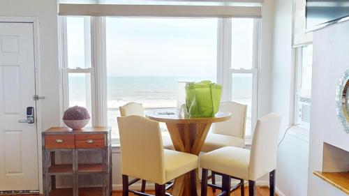 a dining room with a table and chairs and a window at 2 Delightful in Folly Beach