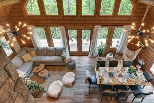 a living room with a couch and a table at Log cabin with HOT TUB and view in La Minerve