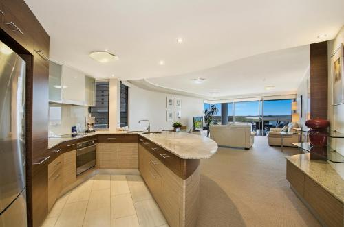 a large kitchen with a large island in the middle at Waves Maroochy River in Maroochydore