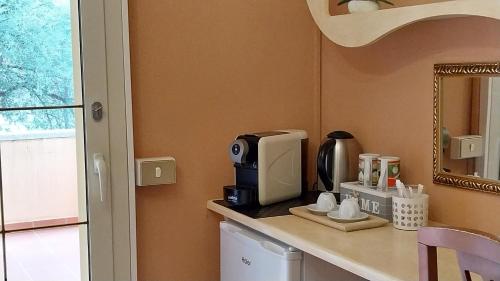 a kitchen with a counter with a coffee maker on it at Li Muntigeddi in San Teodoro