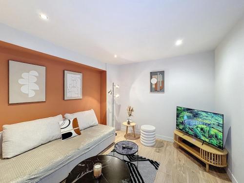 a living room with a couch and a flat screen tv at My Home, voituret 1 in Lyon