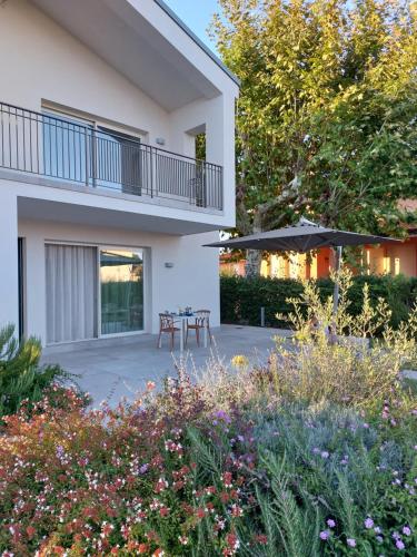 a patio in front of a house with flowers at Slowersilia Bed and Breakfast in Lido di Camaiore