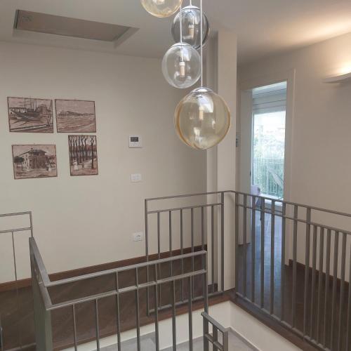 a room with a staircase with three lights at Slowersilia Bed and Breakfast in Lido di Camaiore