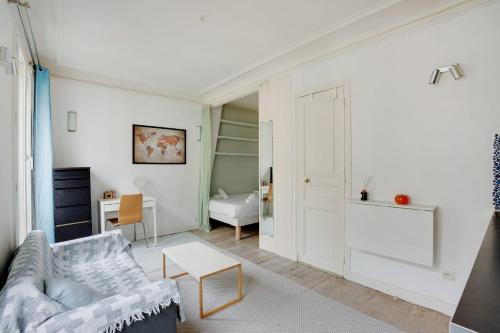 un salon avec un canapé et une table dans l'établissement PARIS 5 - Cosy appartement, à Paris