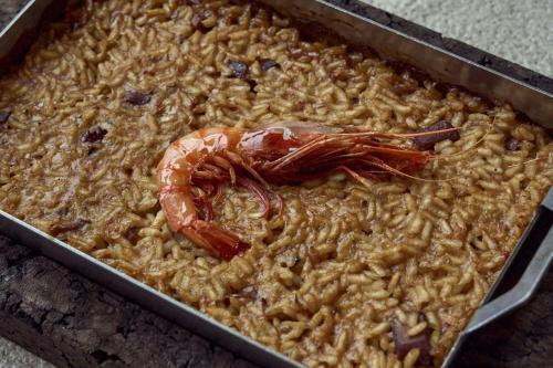 a casserole dish of food with a shrimp on it at Sabàtic Sitges Hotel, Autograph Collection in Sitges