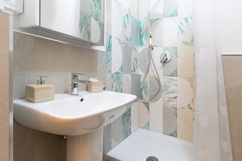 a bathroom with a sink and a mirror at Vatican Cipro Guest House in Rome