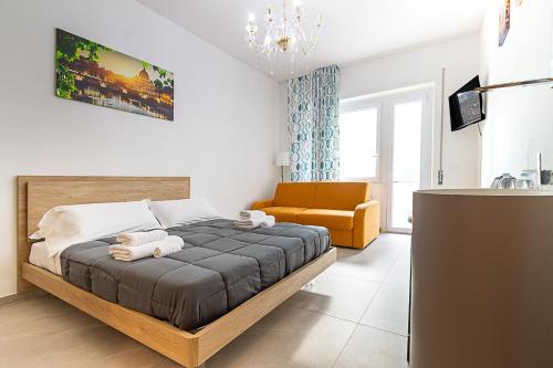 a bedroom with a bed and a chair in it at Vatican Cipro Guest House in Rome