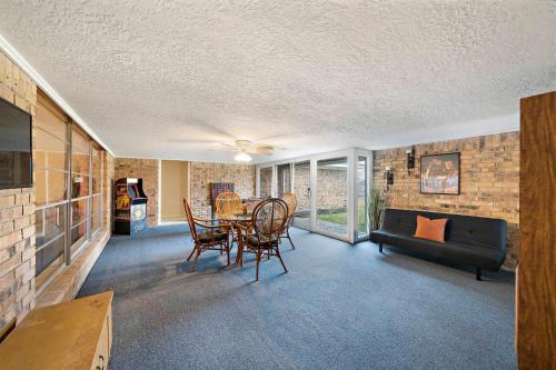 a living room with a table and a couch at Relax and Play 3BR Retreat w Sunroom in Baytown