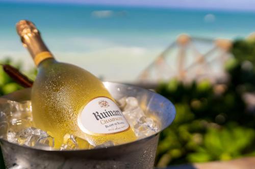 a bottle of champagne in a metal bucket at Casa Paradis Boutique Hotel in Jambiani