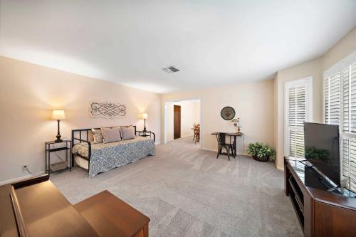 a living room with a couch and a flat screen tv at Relax and Play 3BR Retreat w Sunroom in Baytown