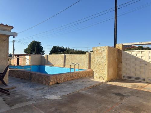 a swimming pool in the backyard of a house at Casita Rural CANTONAL in Valencia
