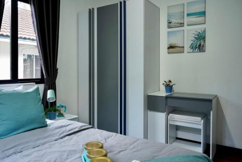 a bedroom with a bed with a table and a desk at บ้านชลดา in Ban Wang Pong