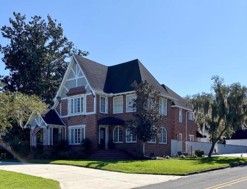 a red brick house with a black roof at Historic Carriage House Downtown 2 bedroom 1 bath in Ocala