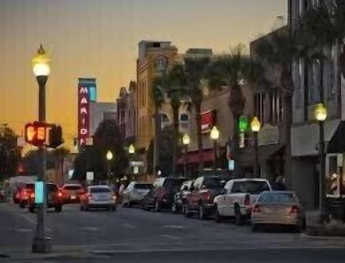 a busy city street with cars parked on the street at Historic Carriage House Downtown 2 bedroom 1 bath in Ocala