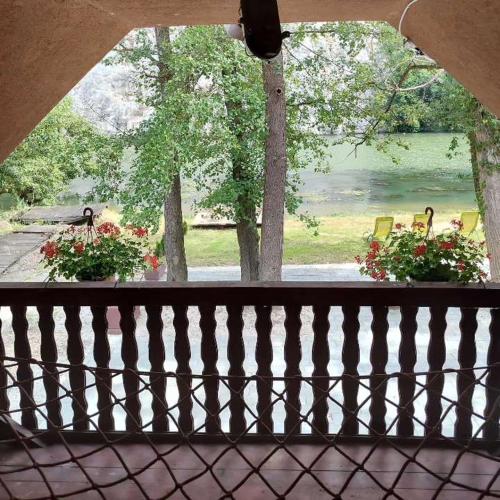 a view of a porch with flowers on a fence at Riverside Cabin in Železnička Stanica Ovčar Banja