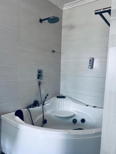 a white bath tub in a bathroom with a sink at Mthuzi Nadi Lodge in Chirundu