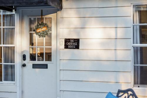 a door of a house with a sign on it at Historic Carriage House Downtown 2 bedroom 1 bath in Ocala